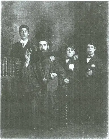 Father Nicola Yanney seated, with his three sons standing around him