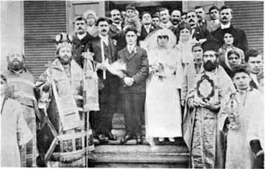 A wedding party and clergy on the steps of a church